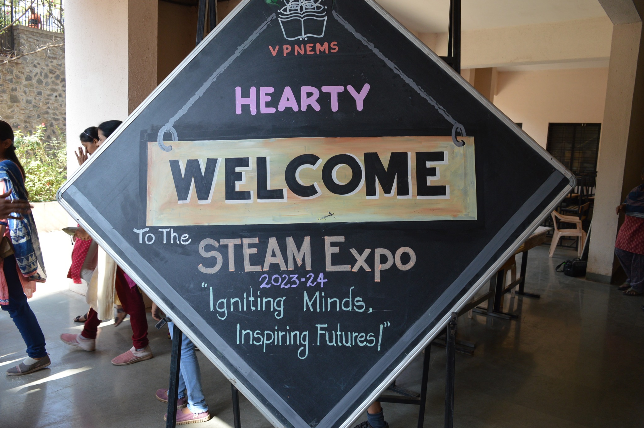 May be an image of 3 people and text that says 'VPNEMS HEARTY WELCOME To The STEAM 2023-24 Expo Igniting Minds, Inspiring Futures!'